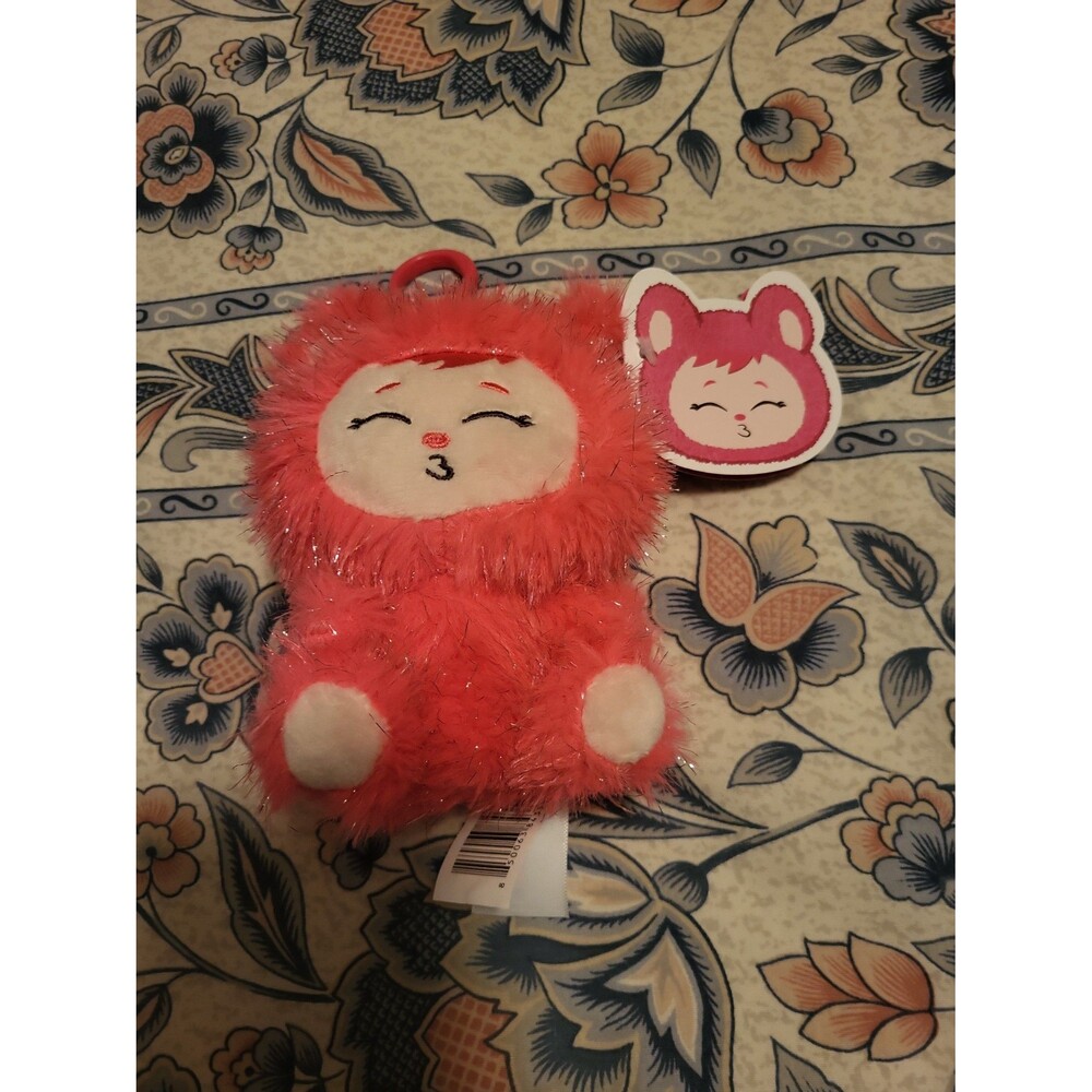 Pink fuzzy stuffed animal plush toy with keychain tag